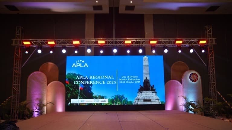 APLA Regional Conference 2025 stage with LED screen and truss lighting